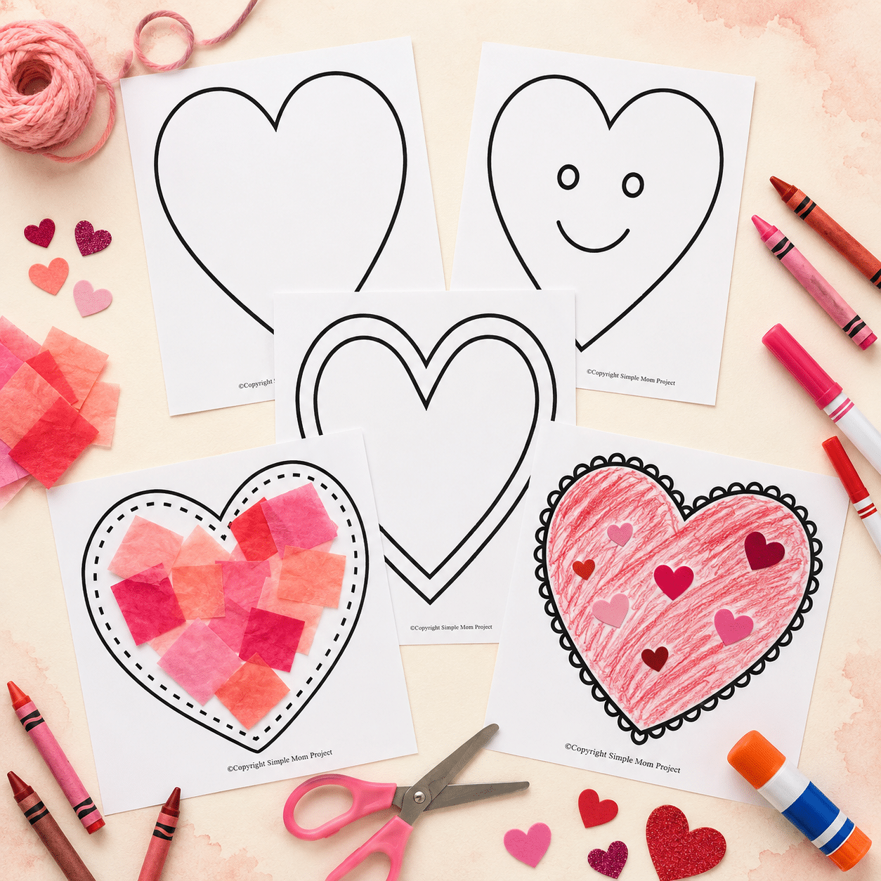 Large printable heart templates displayed with pink and red crayons, tissue paper, stickers and craft supplies.