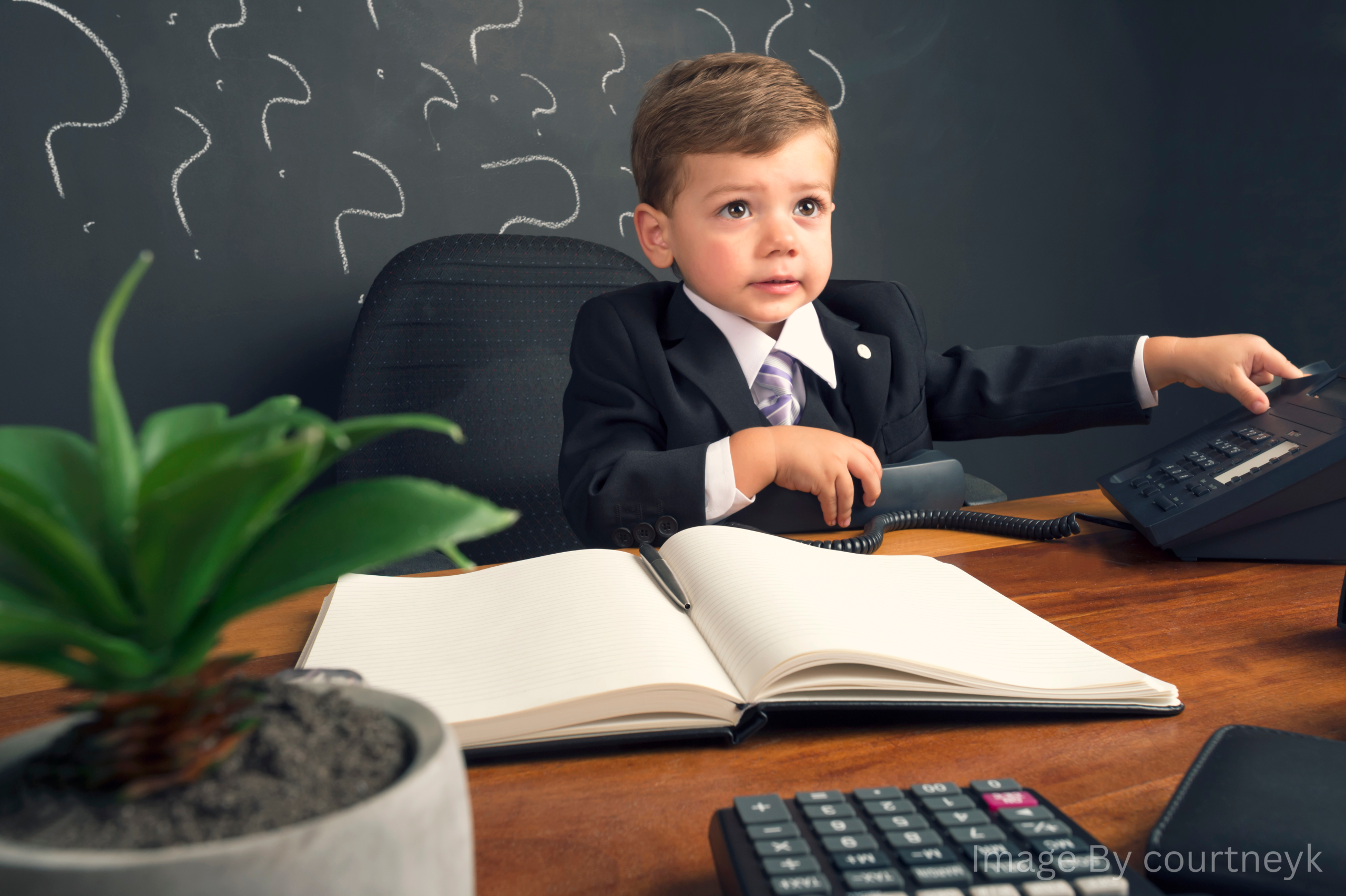 Young child in a suit running a business