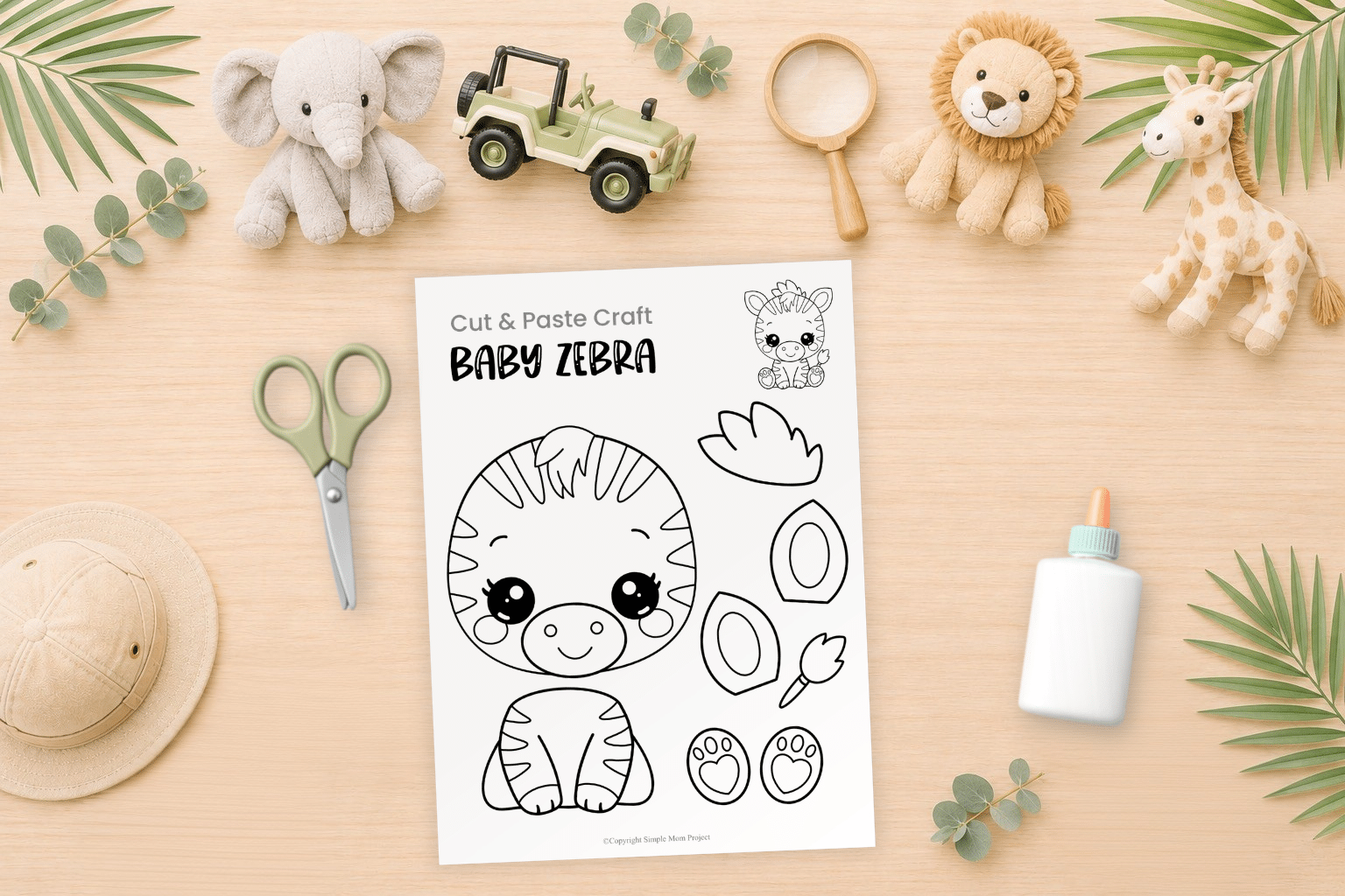 Baby zebra cut and paste craft printable displayed in a preschool craft flatlay with scissors, crayons, and safari-themed supplies.